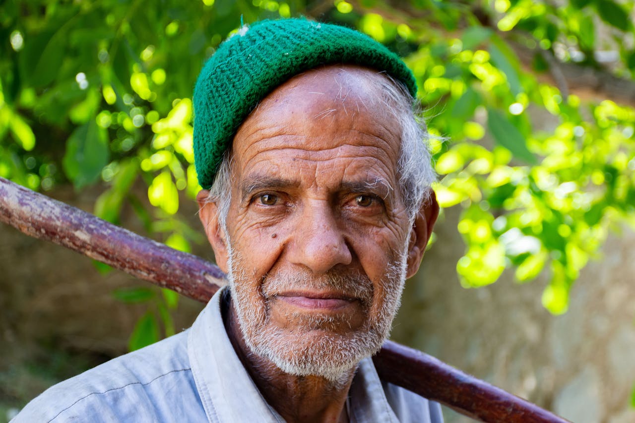 Close-up portrait of an elderly farmer with a warm smile in Yazd, Iran.
